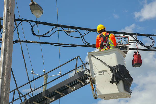 istock Utility Worker on Lift Repairing Power Lines 2217379278