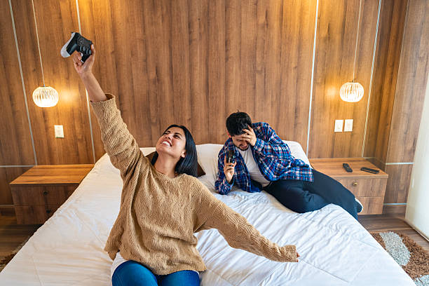 istock POV Gaming Victory: Woman Celebrates Win While Man Reacts to Loss 2217379591