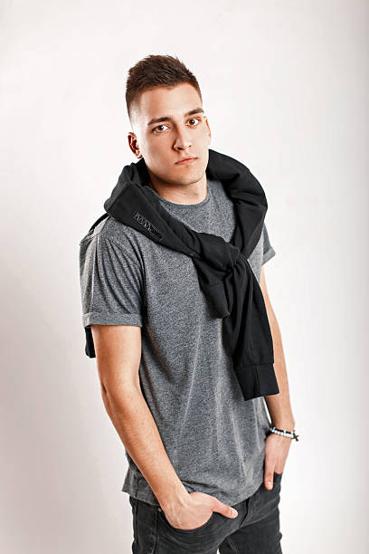 istock Handsome stylish man in a gray t-shirt with a jacket on a white background 2217379687
