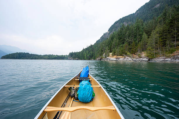 View past canoe bow to ocean and mountains, Howe Sound, Pacific West Coast, B.C.