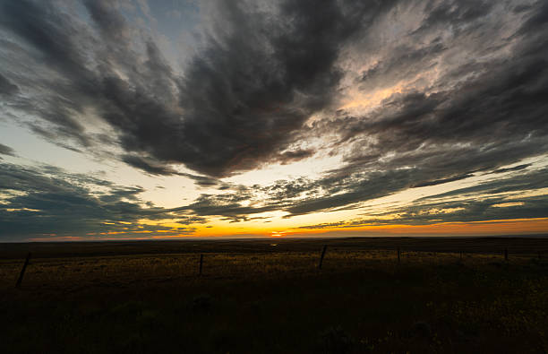istock Sunset colors fill peaceful clouds sky over calm farmland 2217382350