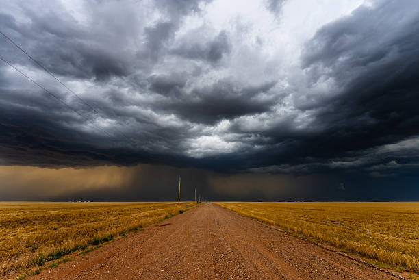 istock Dark storm clouds over a dusty country road 2217382443