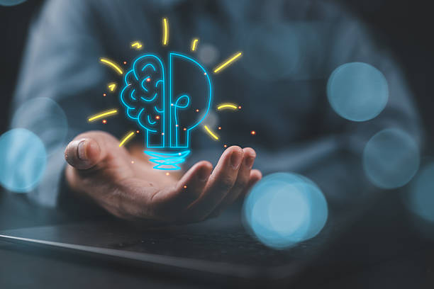 istock Hand holding drawing virtual lightbulb with brain on bokeh background for creative and smart thinking idea concept. 2217383113