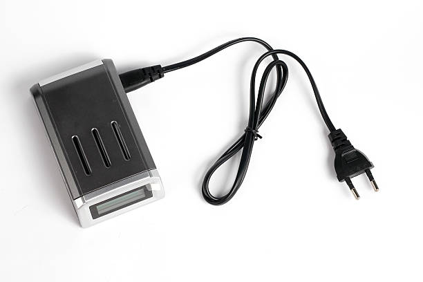 istock battery charger AA attached black cable isolated white background. 2217385499