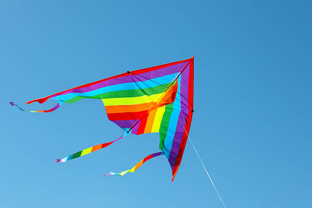 istock One colorful kite flying in blue sky 2217385738