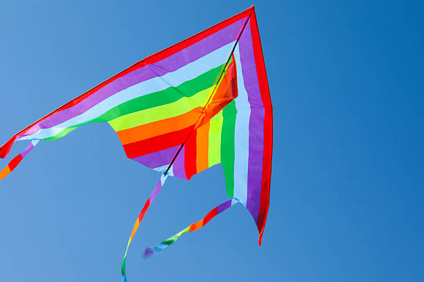 istock One colorful kite flying in blue sky 2217385748