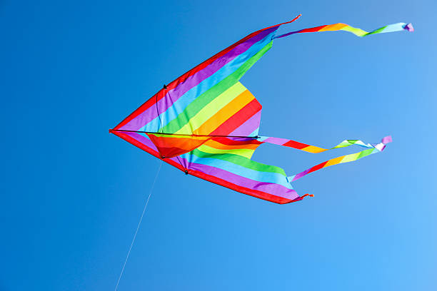 istock One colorful kite flying in blue sky 2217385751