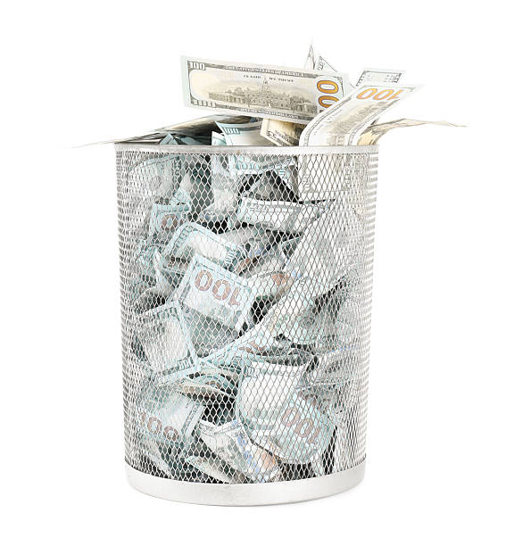 istock Many dollar banknotes in trash bin isolated on white 2217385854