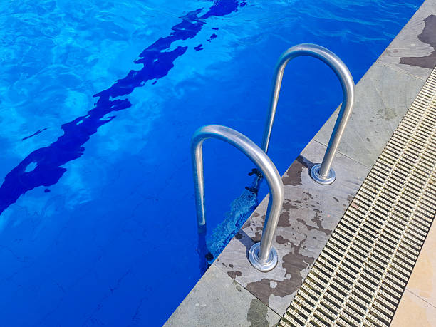 istock Closeup stair in the blue swimming pool background 2217387370