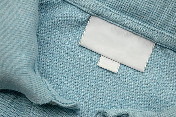 istock White blank laundry care clothes label on blue shirt fabric background 2217387816
