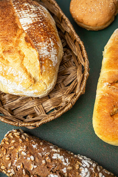 istock Freshly baked bread assortment displayed on a green surface in a basket 2217388974