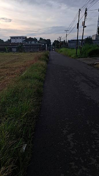 istock Empty Rural Road With Buildings Under an Overcast Sky 2217394281