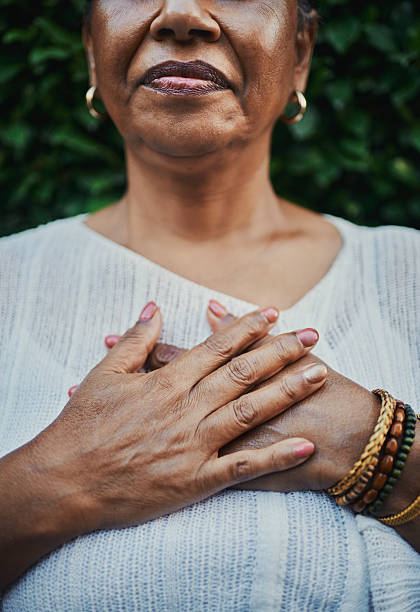 istock Graceful Mature Woman Holding Hands on Chest 2217395926