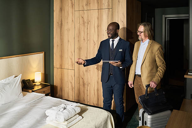 Hotel Manager Greeting Guest in Luxurious Room Setting