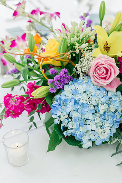 istock Colorful floral centerpiece with candle on white table 2217399754