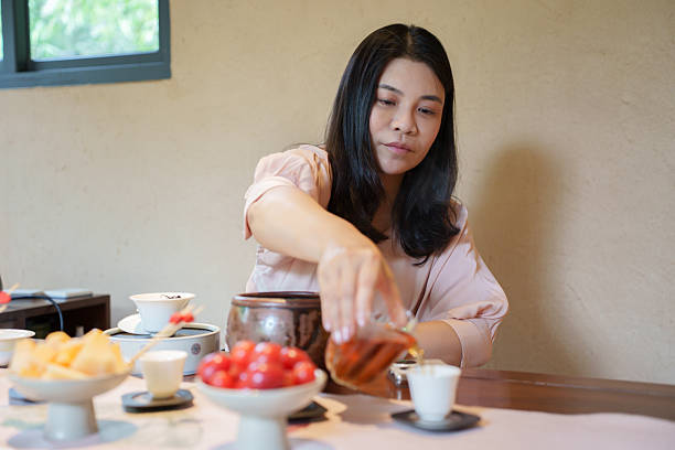 istock Asian woman is making tea in the teahouse 2217402036