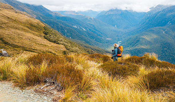 istock Man solo traveling backpacker hiking in wild. 2217402614