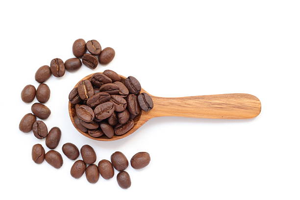 istock Brown coffee beans in spoon on white background 2217402680