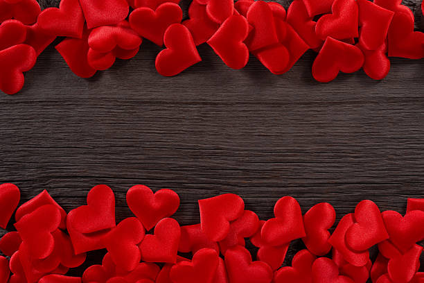 istock Red Hearts on Wooden Background Creating a Romantic and Festive Border Design 2217403970