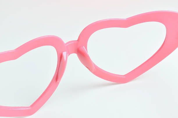 istock pink heart shape of glasses on white background 2217409129
