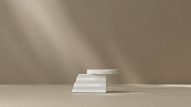 istock An elegantly designed luxury product display platform featuring a sophisticated two-tiered white marble podium positioned on a smooth cream-colored surface. 2217409342