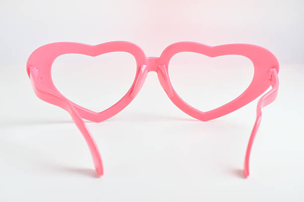 istock pink heart shape of glasses on white background 2217410318