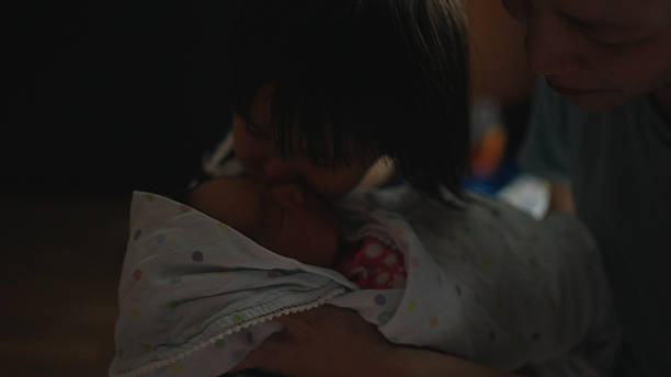 istock Sister playing with newborn baby. 2217411138