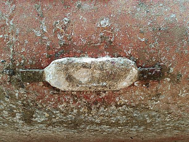 This image shows the worn and corroded condition of a zinc anode on a ship hull after prolonged use