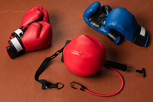 istock Red and blue boxing gloves with a punching bag. Competition concept 2217413658