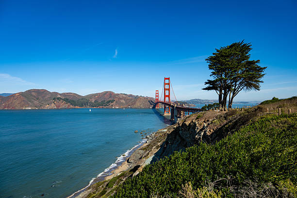 The iconic Golden Gate Bridge in San Francisco, California, spanning across the bay with its striking red towers. This world-famous suspension bridge is a must-see landmark, offering breathtaking views of the city, water, and surrounding hills.