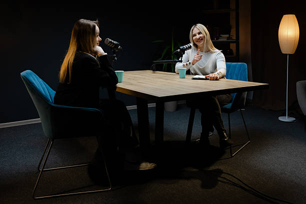 istock Two female podcasters recording a new episode in a professional studio 2217415113