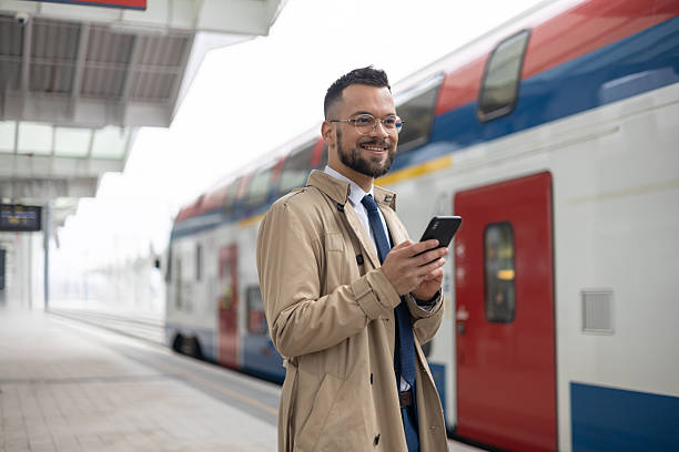 istock A male student is using his smartphone while waiting of train 2217415884
