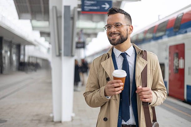 istock Young businessman is standing on train station 2217415889
