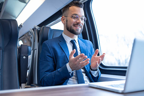 istock Young businessman having a video call while traveling by train 2217415894