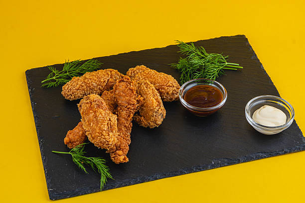 istock Delicious fried chicken wings served with dipping sauces 2217416490