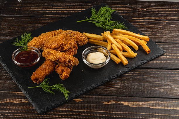 Crispy fried chicken served with golden fries and dipping sauces