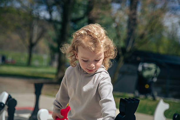 istock Caucasian child playing outdoors on a sunny day in park 2217419638