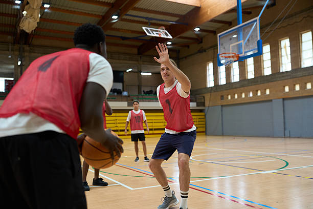 istock Basketball player trying to block opponent during training in gym 2217422955