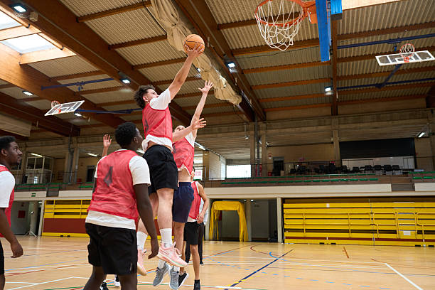 istock Young basketball player shooting ball into hoop during match 2217422962