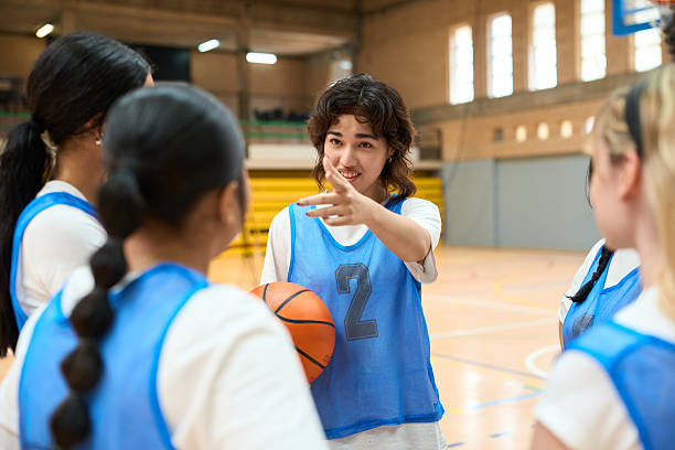 istock Young female basketball player explaining game strategy to teammates 2217423156