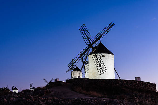 Windmills in Consuegra, Toledo. An icon of La Mancha. The windmills crowns a hill over the town and known worldwide thanks to Don Quixote. Night view
