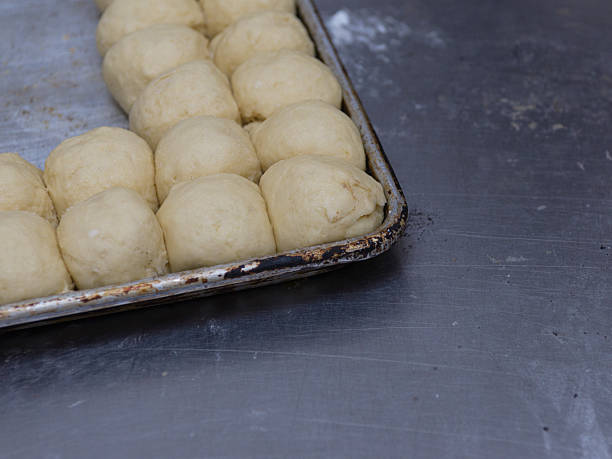 istock A baking sheet holds numerous unbaked dough balls, poised for baking 2217423387