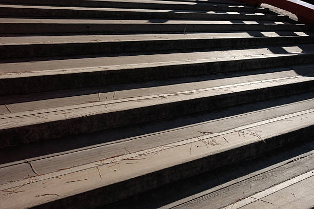 Close-up on a set of wooden stairs shining in the sun.