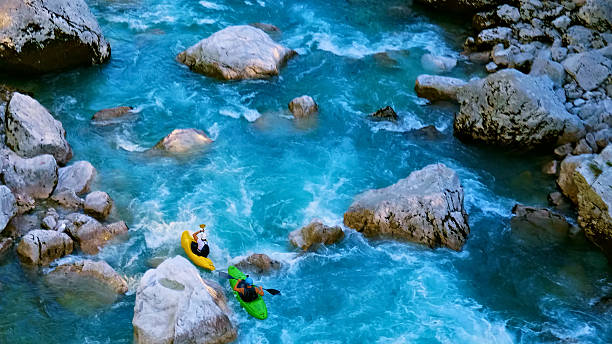 istock Kayakers navigate rapids, conquering the wild blue river 2217425746