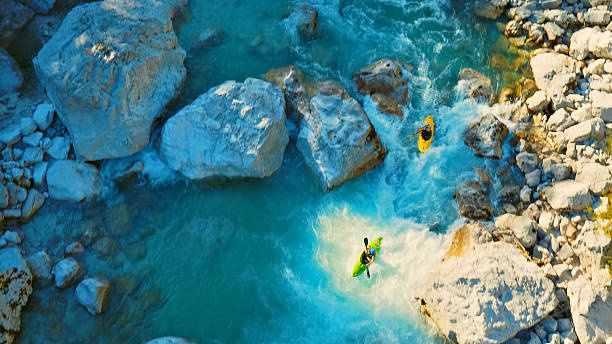 istock Kayaker conquers rapids, navigating through rocky river rapids 2217425756