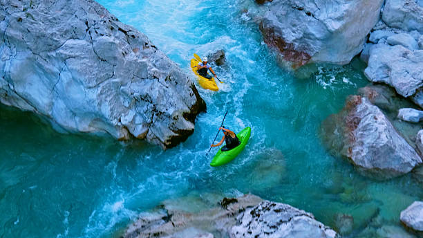 istock Kayakers navigate rapids between rocks in extreme adventure sport 2217425761