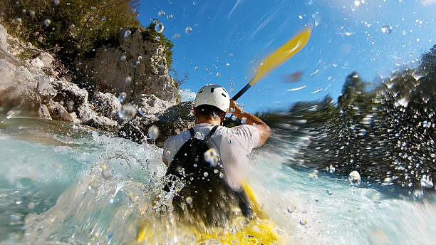 istock Kayaker conquers rapids, splashes, and rocks in thrilling adventure 2217425779