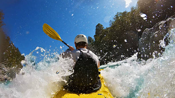 istock A kayaker in a yellow kayak navigates through rough waters 2217425781