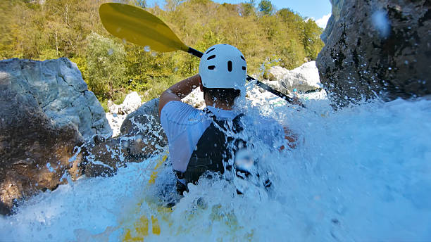istock Kayaker battles rapids, navigating through splashing water and rocks in thrilling whitewater 2217425790