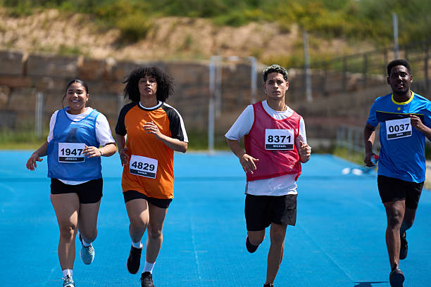 istock Athletes running on blue track during competition 2217426898